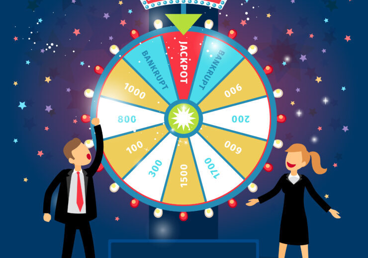 Business people with financial wheel of fortune. Gambling concept